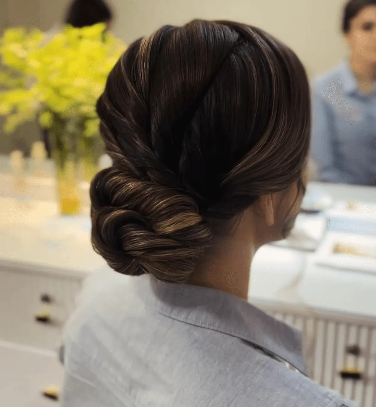 Low sculpted chignon styled at a client’s home